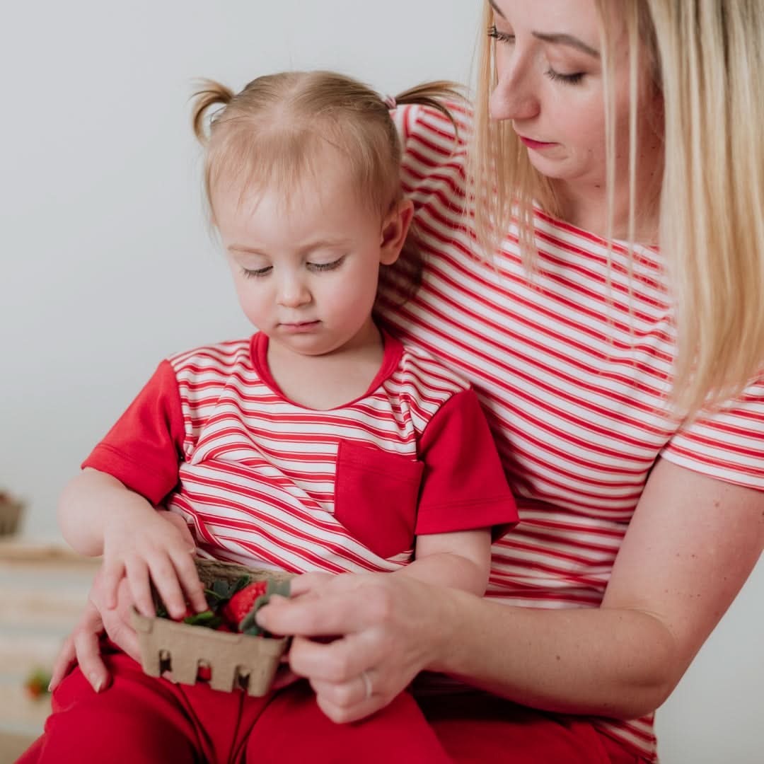 Mother and child enjoying strawberries in a stylish Kids Bamboo Pocket T-shirt