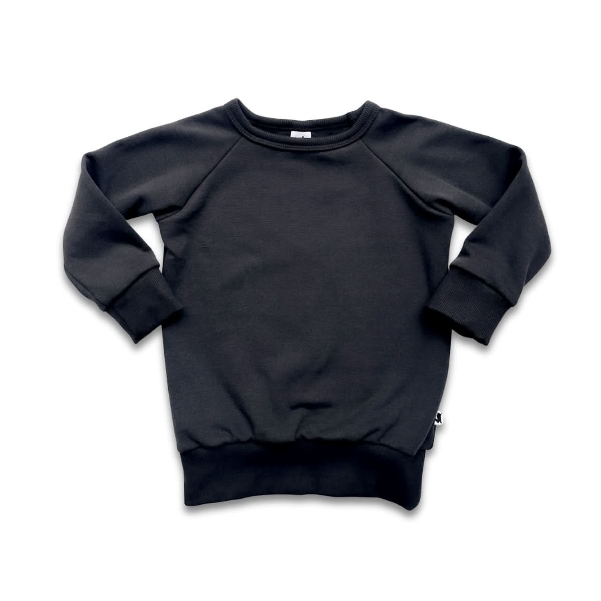 The Little & Lively Baby/Kids Bamboo Fleece Raglan Pullover features long sleeves, ribbed cuffs, collar, and hem. Made from soft bamboo fleece for comfort and ethically produced. Shown in black on a white background.