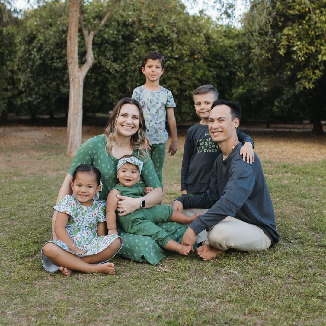 Family portrait on grass featuring stylish Adult Unisex Bamboo Raglan Pullover