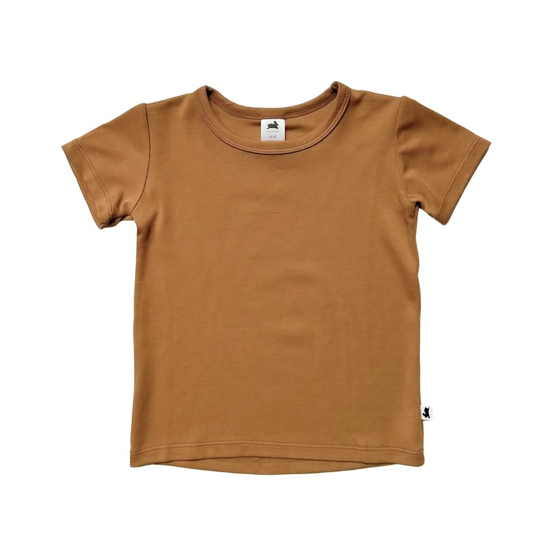 The Little & Lively Youth Bamboo T-shirt, in light brown with short sleeves and a round neckline, is laid flat on a white background. A small fabric tag accents the bottom hem—an ideal basic tee for any tween wardrobe.
