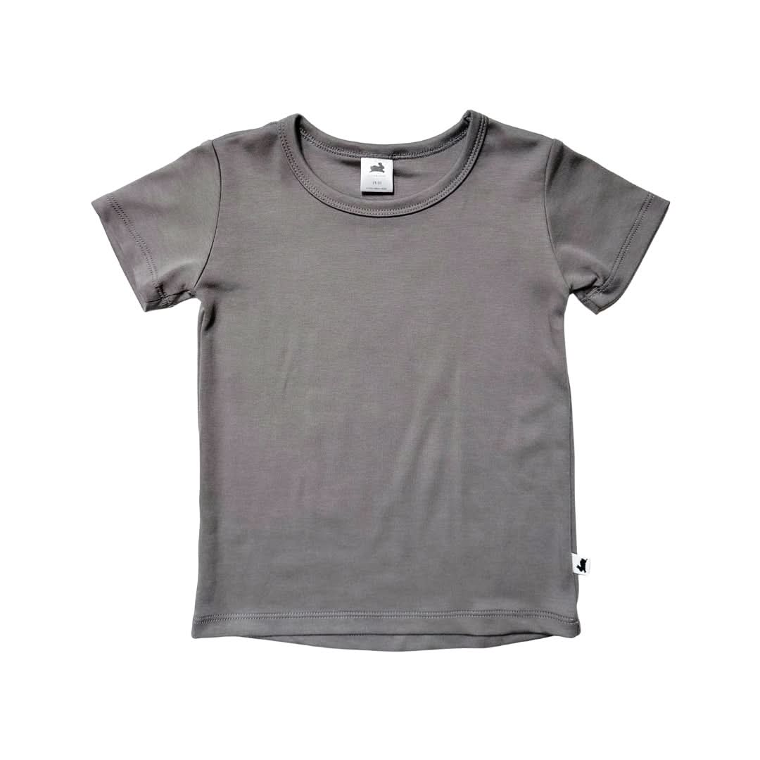 The Little & Lively Baby/Kids Bamboo T-shirt is shown on a white background. This soft bamboo-cotton jersey tee has short sleeves, a round neckline, and a small white tag at the back of the collar.