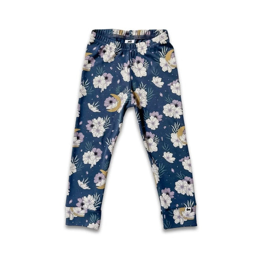 Little & Lively Youth Bamboo Leggings feature an ankle-length fit, navy background with white, purple, and beige floral print, elastic waistband, and soft bamboo-cotton jersey material. Shown flat against a white background.