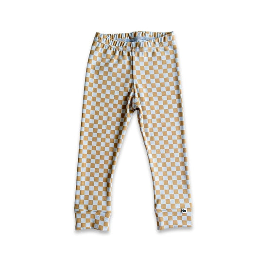 Little & Lively's Kids Bamboo Leggings are ankle-length leggings with a beige and white checkered pattern, elastic waistband, and small tag near the ankle—perfect for comfortable everyday wear.