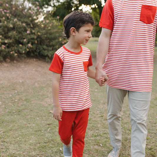 Boy in red and white striped shirt holding hands, wearing Kids Lightweight Bamboo Joggers made from soft cotton alt_CanadaDay