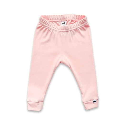 Light pink Baby Bamboo Leggings by Little & Lively, featuring an elastic waistband, folded cuffs, and a small white tag with dark logo on the left cuff. Proudly made in Canada. Displayed on a white background.