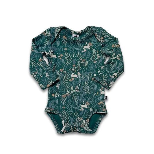 The Little & Lively Bamboo Baby Long-Sleeved Onesie features a dark green nature-themed print with rabbits, birds, and plants. This soft bamboo bodysuit is shown laid flat on a white background.