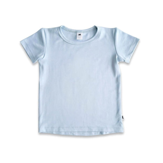 A Baby/Kids Bamboo T-shirt by Little & Lively in light blue is laid flat on a white background, showing its short sleeves, round neckline, and a small white tag at the collar.
