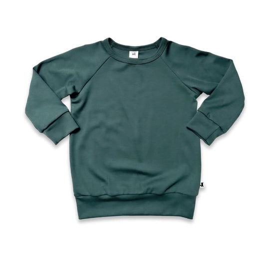 The Little & Lively Baby/Kids Bamboo Raglan Pullover, shown in muted green and laid flat on a white background, features ribbed cuffs, hem, and neckline. Made from a soft, thick, and breathable bamboo fabric for comfortable wear.