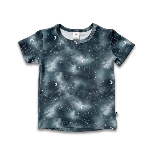 The Little & Lively Baby/Kids Bamboo T-shirt features a dreamy night-sky print with white stars, constellations, and crescent moons on a white background—a perfect breathable tee for little space explorers.